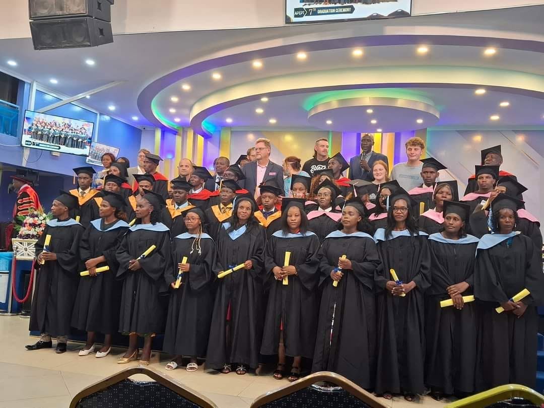APEPT Bible College graduates in academic gowns with the visiting ministry team